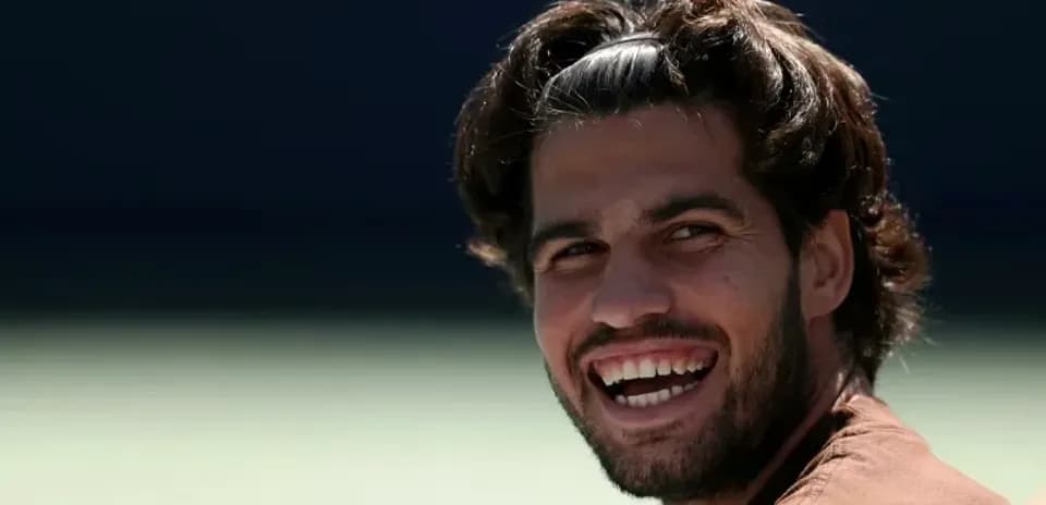 Jugador sonriente en la cancha de tenis