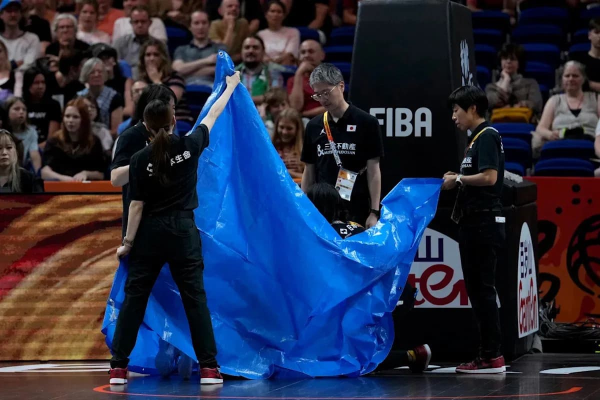 Personal de cancha cubriendo el área con una lona azul