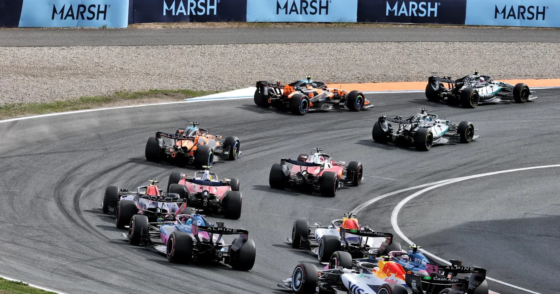 Varios coches de Fórmula 1 en una curva de carrera