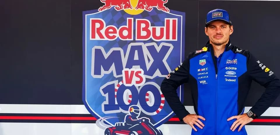 Piloto posando frente a cartel de Red Bull