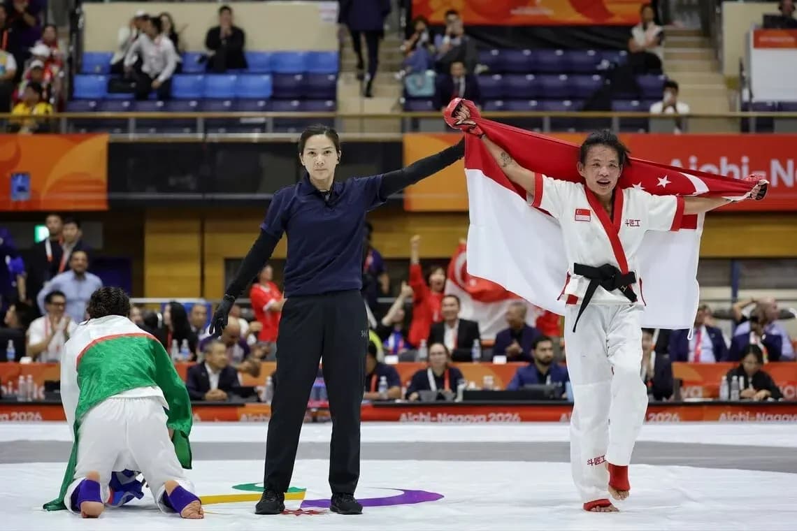 Competitor celebrating victory with national flag