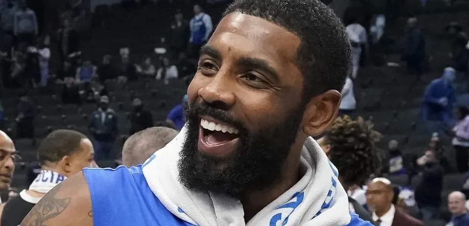 Jugador sonriente con camiseta azul en cancha