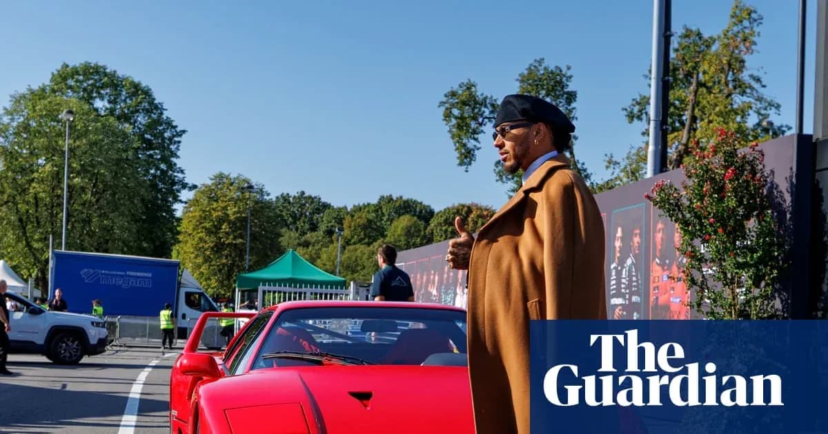 Hombre junto a un coche rojo en evento Hombre junto a un coche rojo en evento