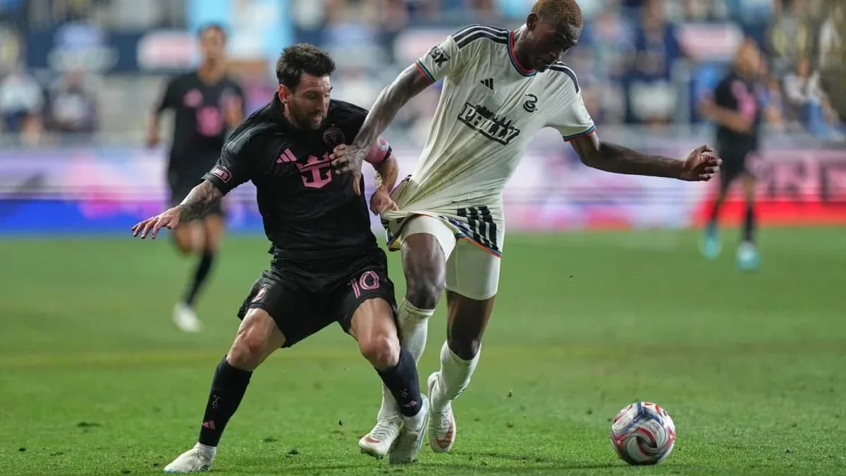 Lionel Messi challenging a Philadelphia player for the ball Lionel Messi challenging a Philadelphia player for the ball